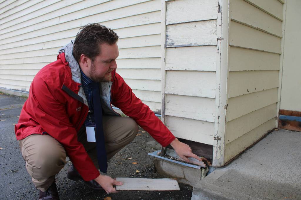 Soldotna Elementary School Principal Dr. Austin Stevenson points out corroded insulation outside of the school building on Friday, Sept. 30, 2022, in Soldotna, Alaska. (Ashlyn OHara/Peninsula Clarion)
