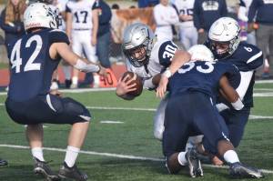Eagle River's Aiden Roschi is stopped by Soldotna's Jakob Kemp, Elijah Lee and Trevor Michael on Saturday, Oct. 1, 2022, at Justin Maile Field at Soldotna High School in Soldotna, Alaska. (Photo by Jeff Helminiak/Peninsula Clarion)