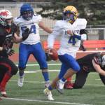 Barrow quarterback Dwight Unutoa runs from Kenai Centrals Alston Thomas on Saturday, Oct. 1, 2022, at Ed Hollier Field at Kenai Central High School in Kenai, Alaska. (Photo by Jeff Helminiak/Peninsula Clarion)