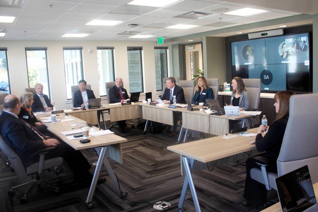 Melanie Hardin, right, greets the Alaska Permanent Fund Corp.s Board of Trustees before her interview for the APFCs executive directors job Monday, Oct. 3, 2022, in Juneau, Alaska. (Mark Sabbatini / Juneau Empire)