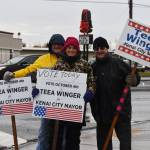Mike McBride, Teea Winger and Jim Glendening wave signs on Election Day, Oct. 4, 2022, in Kenai, Alaska. (Jake Dye/Peninsula Clarion)