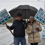 Brian Gabriel and Lisa Gabriel wave signs on Election Day, Oct. 4, 2022, in Kenai, Alaska. (Jake Dye/Peninsula Clarion)