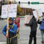 Spencer McLean and his daughter, Emma McLean, show their support for Proposition 3, through which a new CES Station 1 would be constructed in Soldotna, on Tuesday, Oct. 4, 2022, in Soldotna, Alaska. (Ashlyn OHara/Peninsula Clarion)