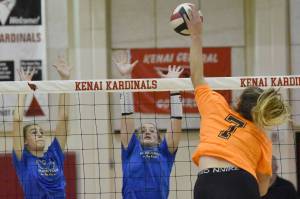 Soldotna's Hallie Fischer and Sadie Lane set up a block on Kenai Central's Emma Beck on Tuesday, Sept. 4, 2022, at Kenai Central High School in Kenai, Alaska. (Photo by Jeff Helminiak/Peninsula Clarion)