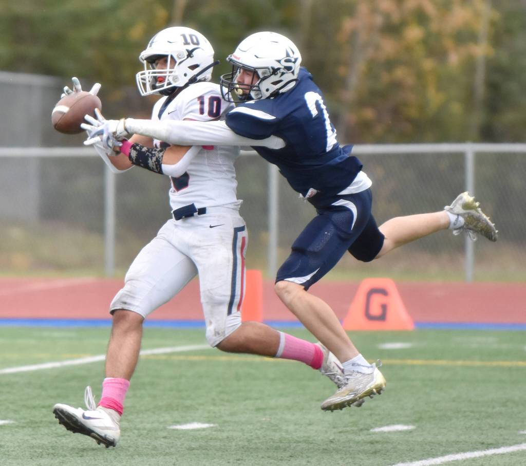 Soldotnas Leigh Tacey breaks up a pass for North Poles Logan Fischer on Friday, Oct. 7, 2022, at Justin Maile Field at Soldotna High School in Soldotna, Alaska. (Photo by Jeff Helminiak/Peninsula Clarion)