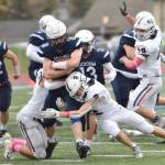 Soldotnas Collin Peck is tackled by North Poles Logan Fischer and Trevor Walters on Friday, Oct. 7, 2022, at Justin Maile Field at Soldotna High School in Soldotna, Alaska. (Photo by Jeff Helminiak/Peninsula Clarion)
