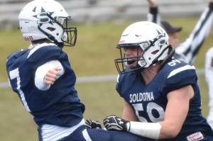 Zac Buckbee and Joe Whittom celebrate after Buckbee's touchdown run in the first quarter Friday, Oct. 7, 2022, at Justin Maile Field at Soldotna High School in Soldotna, Alaska. (Photo by Jeff Helminiak/Peninsula Clarion)