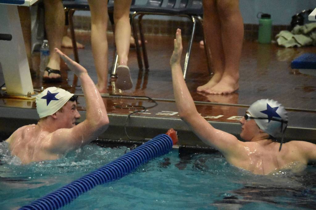 Soldotnas Benn Abel and Derrick Jones celebrate after swimming the 50-yard freestyle at the SoHi Pentathlon on Friday, Oct. 7, 2022, at Soldotna High School in Soldotna, Alaska. (Jake Dye/Peninsula Clarion)