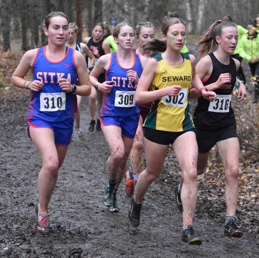 Sitkas Anna Prussian, Sitkas Claire Mullin, Sewards Hailey Ingalls and Kenai Centrals Jayna Boonstra lead the field in the Division II girls race at the state cross-country meet Saturday, Oct. 8, 2022, at Bartlett High School in Anchorage, Alaska. (Photo by Jeff Helminiak/Peninsula Clarion)