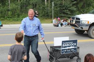 2022 Alaska State Senate candidate Tuckerman Babcock hands out candy during the 65th annual Soldotna Progress Days Parade on Saturday, July 23, 2022, in Soldotna, Alaska. (Ashlyn OHara/Peninsula Clarion)