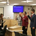 From left: Kenai Peninsula Borough Clerk Johni Blankenship swears in newly reelected assembly members Tyson Cox, Brent Johnson and Jesse Bjorkman during a meeting on Tuesday, Oct. 11, 2022. (Ashlyn OHara/Peninsula Clarion)