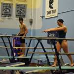 Abriella Werner approaches the end of the diving board, Derrick Jones watches during a dive practice on Tuesday, Oct. 11, 2022, at Soldotna High School in Soldotna, Alaska. (Jake Dye/Peninsula Clarion)