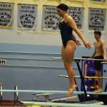 Abriella Werner leaps as she approaches the end of the diving board, Shonia Werner and Derrick Jones watch during a dive practice on Tuesday, Oct. 11, 2022, at Soldotna High School in Soldotna, Alaska. (Jake Dye/Peninsula Clarion)