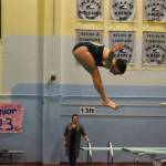 Abriella Werner performs a reverse dive during a practice on Tuesday, Oct. 11, 2022 at Soldotna High School in Soldotna, Alaska. (Jake Dye/Peninsula Clarion)