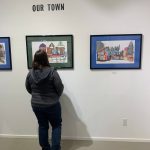 A community member views work in the Our Town exhibit at Fireweed Gallery during First Friday, Oct. 7, 2022, in Homer, Alaska. (Photo by Christina Whiting/Homer News)