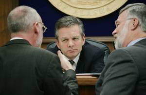 Then-Alaska State Senate President Ben Stevens, R-Anchorage, center, and Sen. Gary Stevens, R-Kodiak right, listen to Sen. Kim Elton, D-Juneau, May 3, 2006, during a Senate floor session at the Capitol in Juneau, Alaska. Ben Stevens, a former Alaska Senate president and a son of the late U.S. Sen. Ted Stevens, died on Thursday, Oct. 13, 2022. He was 63. (AP Photo/Seanna OSullivan, File)
