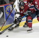 Kenai River's Hayden Walters battles for the puck with Davis Ormins and Sam Berry of the Fairbanks Ice Dogs on Friday, Oct. 14, 2022, at the Soldotna Regional Sports Complex in Soldotna, Alaska. (Photo by Jeff Helminiak/Peninsula Clarion)
