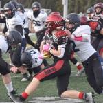 Houstons Noah Whitted is tackled by Homers Chris Martishev on Saturday, Oct. 15, 2022, in the Division III state championship game at Service High School in Anchorage, Alaska. (Photo by Jeff Helminiak/Peninsula Clarion)