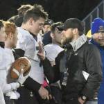 Homer head coach Justin Zank shares a moment with quarterback Carter Tennison after winning the Division III state championship Saturday, Oct. 15, 2022, at Service High School in Anchorage, Alaska. (Photo by Jeff Helminiak/Peninsula Clarion)