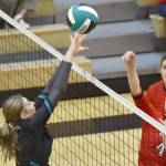 Kenai Central's Avia Miller attacks on Nikiski's Ashlynne Playle on Tuesday, Oct. 18, 2022, at Nikiski High School in Nikiski, Alaska. (Photo by Jeff Helminiak/Peninsula Clarion)