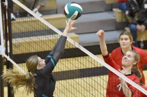 Kenai Central's Avia Miller attacks on Nikiski's Ashlynne Playle on Tuesday, Oct. 18, 2022, at Nikiski High School in Nikiski, Alaska. (Photo by Jeff Helminiak/Peninsula Clarion)