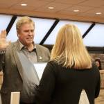 Kenai City Clerk Shellie Saner, right, swears in Kenai Mayor Brian Gabriel during a Kenai City Council meeting on Wednesday, Oct. 19, 2022, in Kenai, Alaska. (Ashlyn OHara/Peninsula Clarion)
