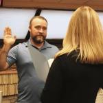 Kenai City Clerk Shellie Saner, right, swears in Alex Douthit during a Kenai City Council meeting on Wednesday, Oct. 19, 2022, in Kenai, Alaska. (Ashlyn OHara/Peninsula Clarion)