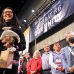 U.S. Rep. Mary Peltola, left, acknowledges audience members singing a song of prayer for her at the Alaska Federation of Natives conference in Anchorage on Thursday. Peltola, a Democrat, is the first Alaska Native to be elected to Congress. (AP Photo / Mark Thiessen)