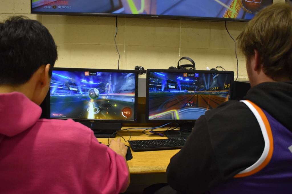 Dalton Schanrock maintains possession of the ball while Bryce LeFevre hangs back in goal during SoHi's Rocket League match against Thunder Mountain on Thursday, Oct. 20, 2022 in Soldotna, Alaska. (Jake Dye/Peninsula Clarion)