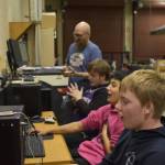 From left, Coach Jonus Kaponus Angleton, Bryce LeFevre, Dalton Schanrock and Graehm LeFevre celebrate victory during SoHi's Rocket League match against Thunder Mountain High School on Thursday, Oct. 20, 2022 at Skyview Middle School in Soldotna, Alaska. (Jake Dye/Peninsula Clarion)