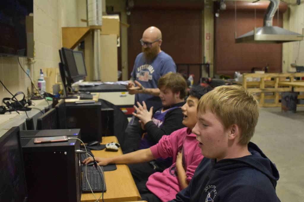 From left, Coach Jonus Kaponus Angleton, Bryce LeFevre, Dalton Schanrock and Graehm LeFevre celebrate victory during SoHi's Rocket League match against Thunder Mountain High School on Thursday, Oct. 20, 2022 at Skyview Middle School in Soldotna, Alaska. (Jake Dye/Peninsula Clarion)