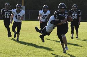 Nikiskis Dwyght Mullins is tackled by Homers Austin Hanson on Friday, Sept. 23, 2022, at Nikiski High School in Nikiski, Alaska. (Jake Dye/Peninsula Clarion)
