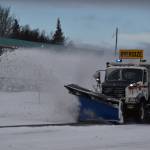 A plow truck clears snow as it moves down the Kenai Spur Highway in Kenai, Alaska on Wednesday, Oct. 26, 2022. (Jake Dye/Peninsula Clarion)
