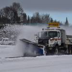 A plow truck clears snow as it moves down the Kenai Spur Highway in Kenai, Alaska on Wednesday, Oct. 26, 2022. (Jake Dye/Peninsula Clarion)