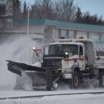 A plow truck clears snow as it moves down the Kenai Spur Highway in Kenai, Alaska on Wednesday, Oct. 26, 2022. (Jake Dye/Peninsula Clarion)