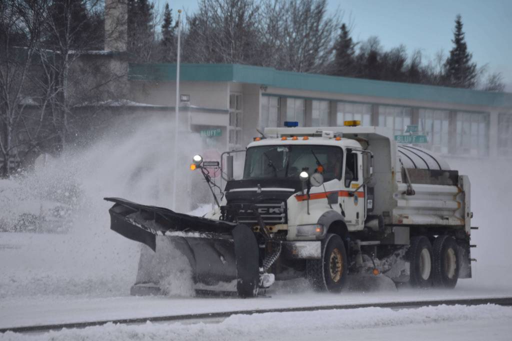 A plow truck clears snow as it moves down the Kenai Spur Highway in Kenai, Alaska on Wednesday, Oct. 26, 2022. (Jake Dye/Peninsula Clarion)