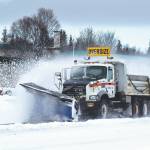 A plow truck clears snow as it moves down the Kenai Spur Highway in Kenai on Wednesday. (Jake Dye/Peninsula Clarion)
