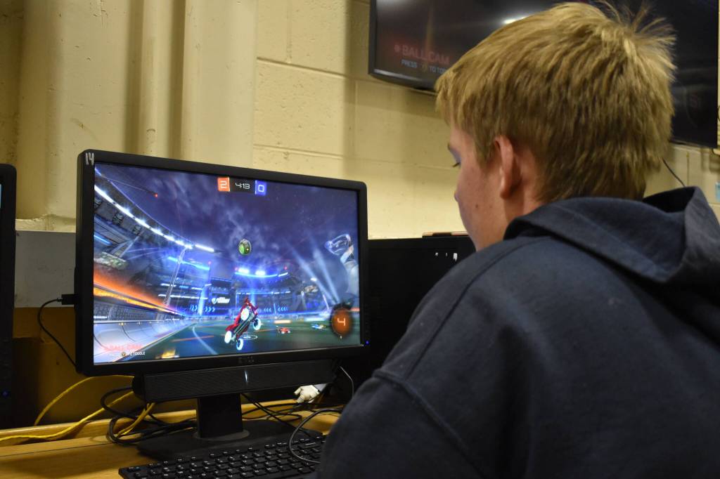 Graehm LeFevre watches the ball soar through the air during SoHis Rocket League match against Thunder Mountain High School on Thursday, Oct. 20, 2022 at Skyview Middle School in Soldotna, Alaska. (Jake Dye/Peninsula Clarion)
