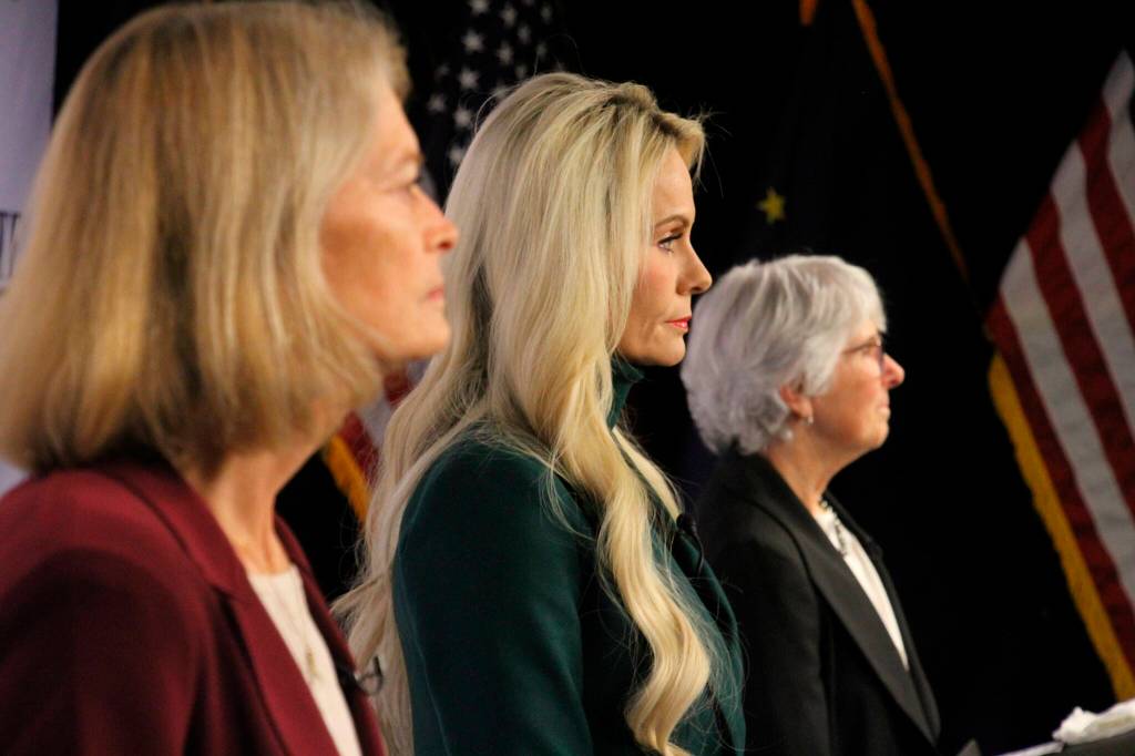 Republican Kelly Tshibaka, center, a Republican, looks on Thursday, Oct. 27, 2022, prior to a U.S. Senate debate in Anchorage, Alaska. She faces U.S. Sen. Lisa Murkowski, left, and Democrat Pat Chesbro, right, in the general election. (AP Photo/Mark Thiessen)