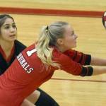 Kenai Central's Kimberly Chanley digs up a ball in front of Jaycie Castillo on Friday, Oct. 28, 2022, at Kenai Central High School in Kenai, Alaska. (Photo by Jeff Helminiak/Peninsula Clarion)