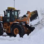 Snow is cleared from a parking lot at the Kenai Municipal Airport on Wednesday, Nov. 2, 2022 in Kenai, Alaska. (Jake Dye/Peninsula Clarion)