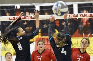 Kenai Central's Cali Holmes (3) watches her spike get past Nikiski's Alexa Iyatunguk and Savanna Stock on Thursday, Nov. 3, 2022, at the Southcentral Conference volleyball tournament at Kenai Central High School in Kenai, Alaska. (Photo by Jeff Helminiak/Peninsula Clarion)
