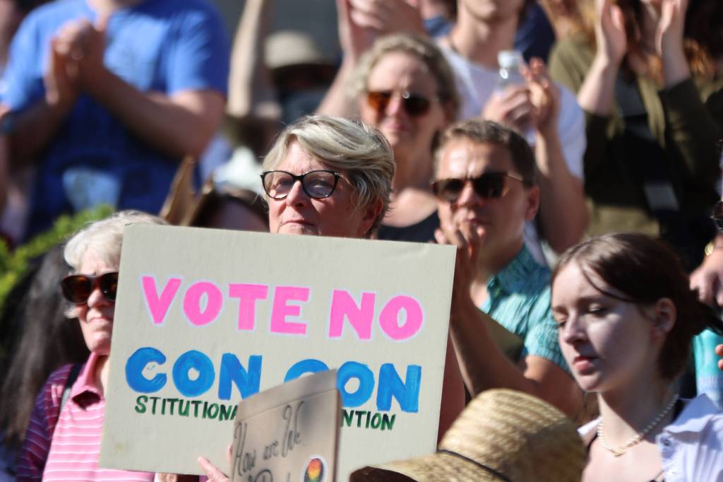 Former Democratic state Rep. Beth Kerttula holds up a sign reading Vote No Con Con, during a recent rally at the Dimond Courthouse Plaza in Juneau. Ben Hohenstatt / Juneau Empire File)