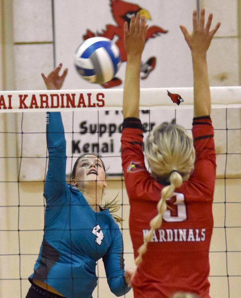 Nikiskis Savanna Stock attacks Kenai Centrals Cali Holmes on Saturday, Nov. 5, 2022, at the Southcentral Conference volleyball tournament at Kenai Central High School in Kenai, Alaska. (Photo by Jeff Helminiak/Peninsula Clarion)