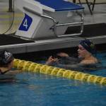 Samantha Schwarting, of Juneau Douglas High School, and Carly Nelson, of Homer, celebrate together after completing the 500-yard freestyle during finals at the ASAA State Swim & Dive Championships on Saturday, Nov. 5, 2022, at Bartlett High School in Anchorage, Alaska. The two swam neck and neck for much of the race, but Nelson claimed first place. (Jake Dye/Peninsula Clarion)