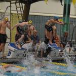 Jackson Bird, of Seward, performs a relay start over teammate Nickolas Ambrosiani during the 200-yard freestyle relay during finals at the ASAA State Swim & Dive Championships on Saturday, Nov. 5, 2022, at Bartlett High School in Anchorage, Alaska. (Jake Dye/Peninsula Clarion)