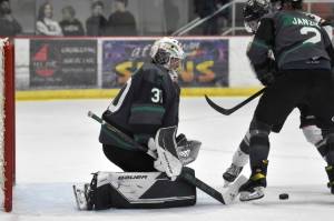 Minnesota Wilderness defenseman Beau Janzig seals Kenai River Brown Bears forward Noah Holt from Wilderness goalie Isak Posch on Saturday, Nov. 5, 2022, at the Soldotna Regional Sports Complex in Soldotna, Alaska. (Photo by Jeff Helminiak/Peninsula Clarion)