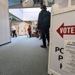A sign directs early voters to the polling station at the Mendenhall Mall on Monday. The mall is one of two early voting locations in Juneau, but more than a dozen polling locations will be open from 7 a.m. to 8 p.m. on Tuesday. (Ben Hohenstatt / Juneau Empire)