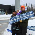 From left, Jamie, Brinna and Jesse Bjorkman wave signs supporting Jesse Bjorkmans bid for Alaska State Senate at the intersection of the Kenai Spur and Sterling highways on Tuesday, Nov. 8, 2022 in Soldotna, Alaska. (Ashlyn OHara/Peninsula Clarion)