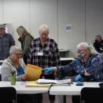 K-Beach Precinct Chair Kathy Carson (right) assists Carol Louthan (left) with a folder of spoiled ballots at the Soldotna Regional Sports Complex on Tuesday, Nov. 8, 2022 in Soldotna, Alaska. (Ashlyn O'Hara/Peninsula Clarion)